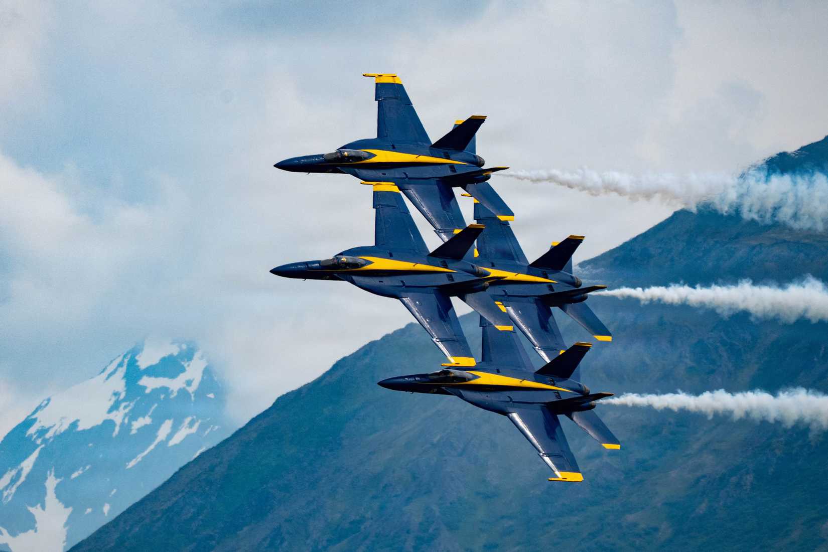 Navy FA-18 Super Hornet aircraft with the flight demonstration squadron, the Blue Angels, fly in diamond formation during the Arctic Thunder Open House