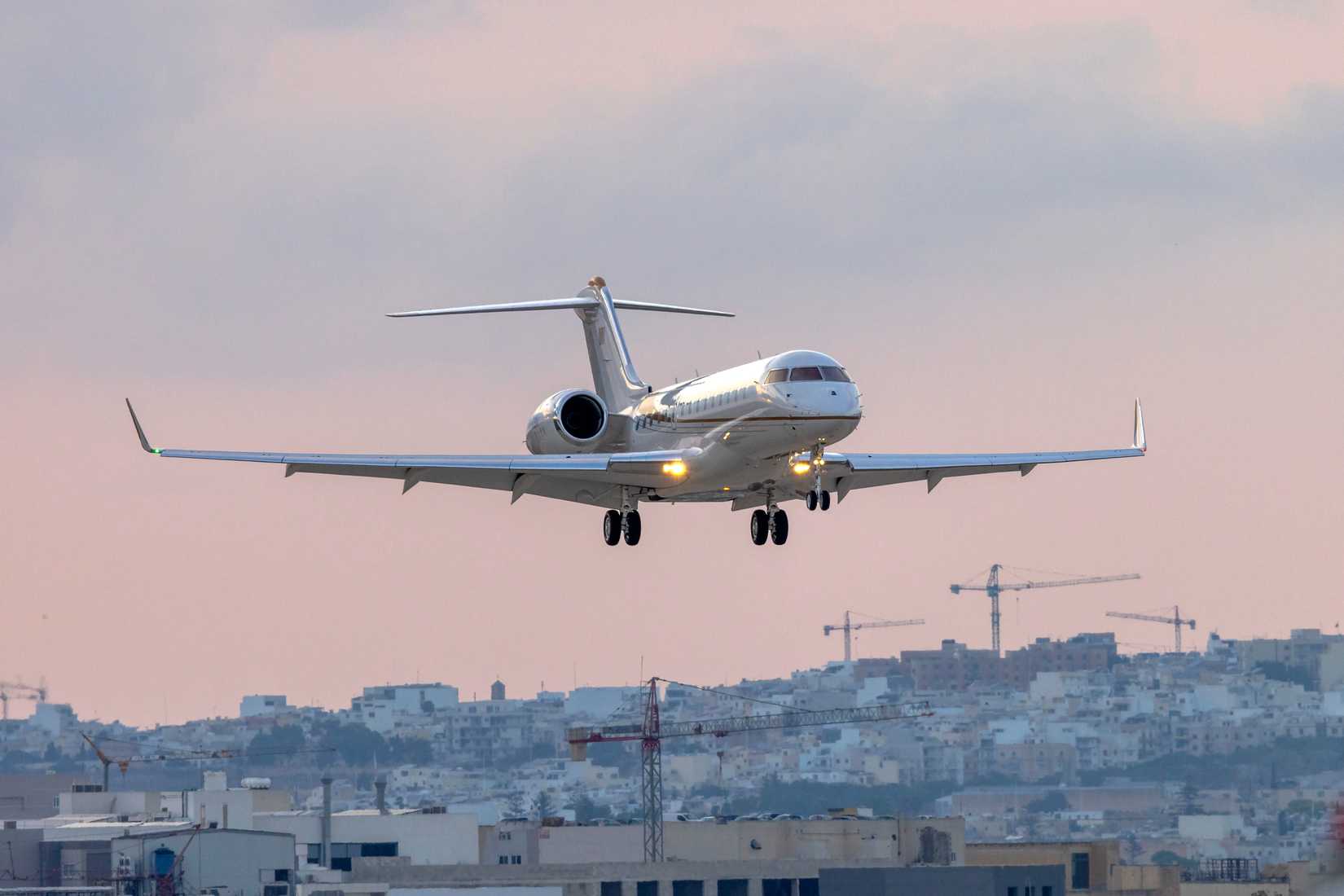 Private Australian registered Bombardier BD-700-1A10 Global 6500 (REG VP-CSH) landing after sunset.