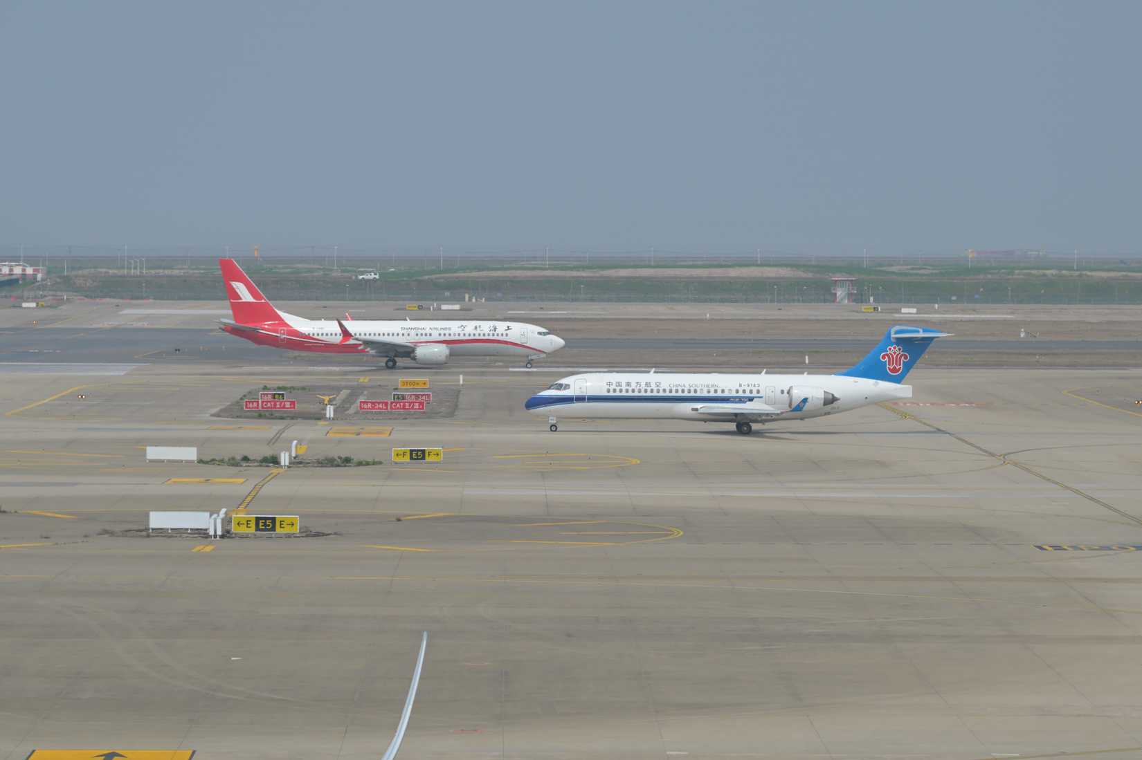 Shanghai_Airlines_Boeing_737-8_MAX_and_China_Southern_Comac_C909_at_Shanghai_Pudong_June_2025
