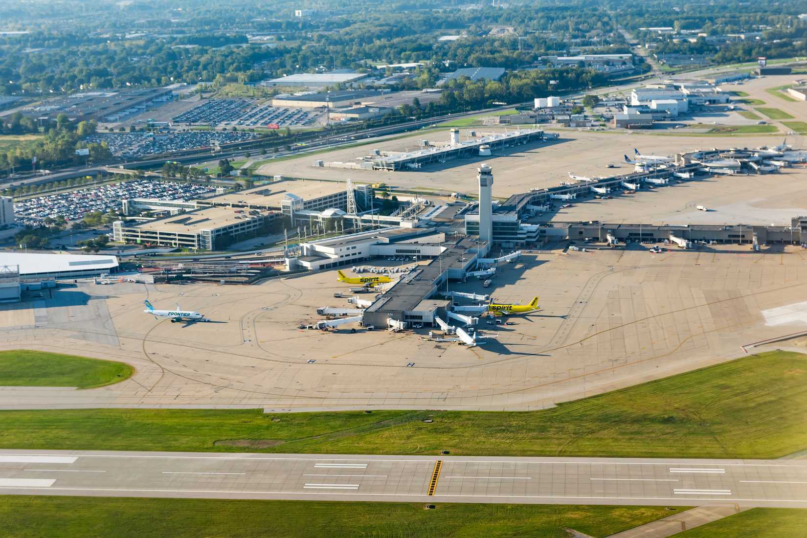 Cleveland, OH, USA - September 19, 2021: Aerial view of Cleveland Hopkins International airport terminal, tower and apron with airplanes from ascending plane