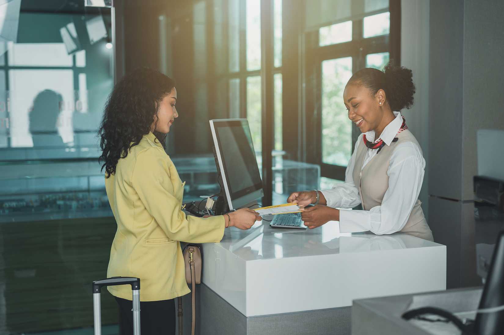 Tourists are chatting with flight attendants about travel tickets.