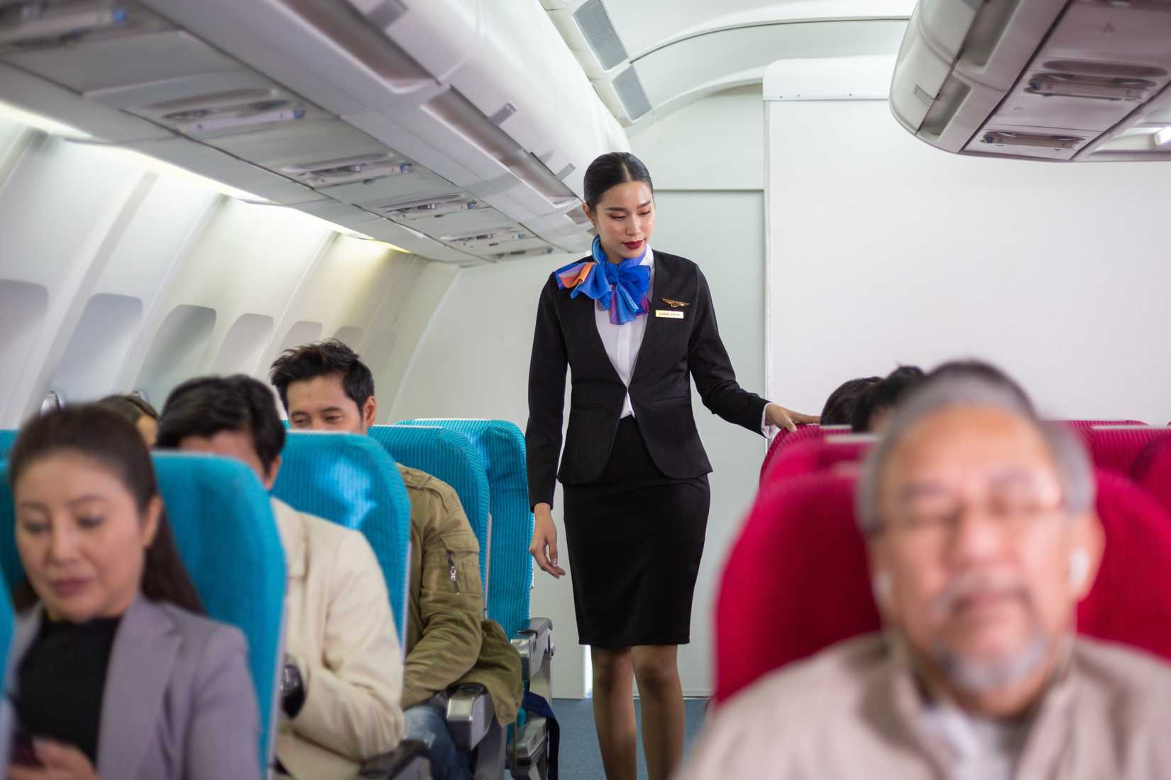 Flight attendant in the aisle