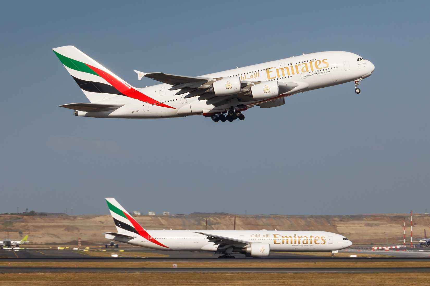 Emirates Airbus A380-800 Climbing With Boeing 777-300ER Taxiing
