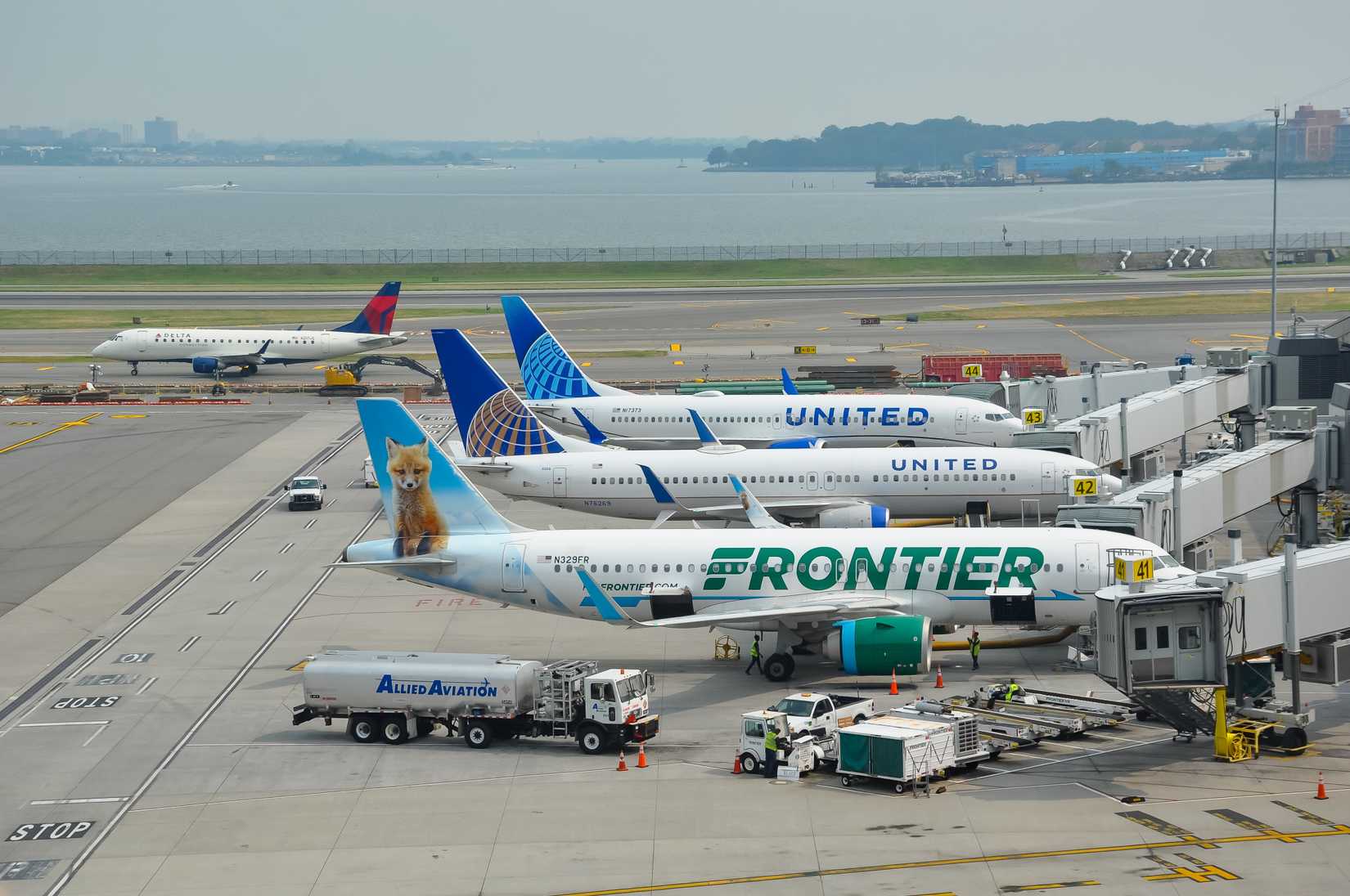 New York, USA - August 4, 2025: Frontier and United Airlines aircraft seen parked at the tarmac of La Guardia International Airport in New York.