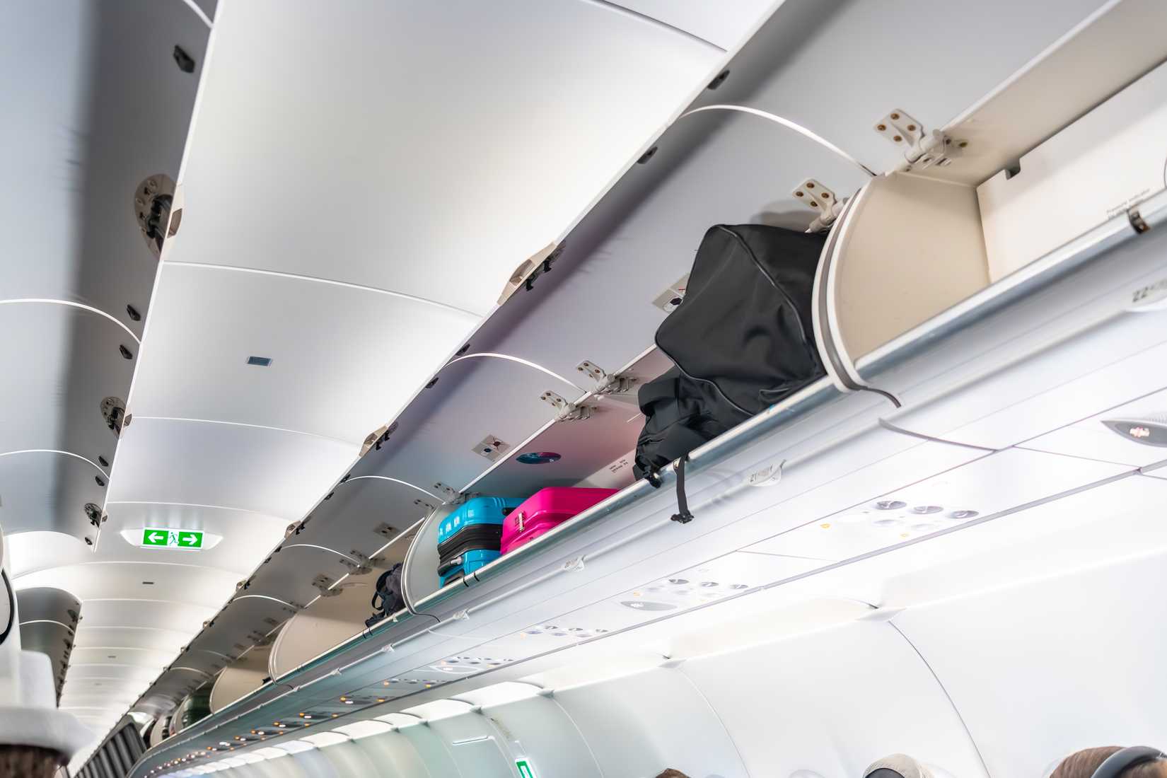 Carry on luggage and bags inside the overhead compartments of an airplane