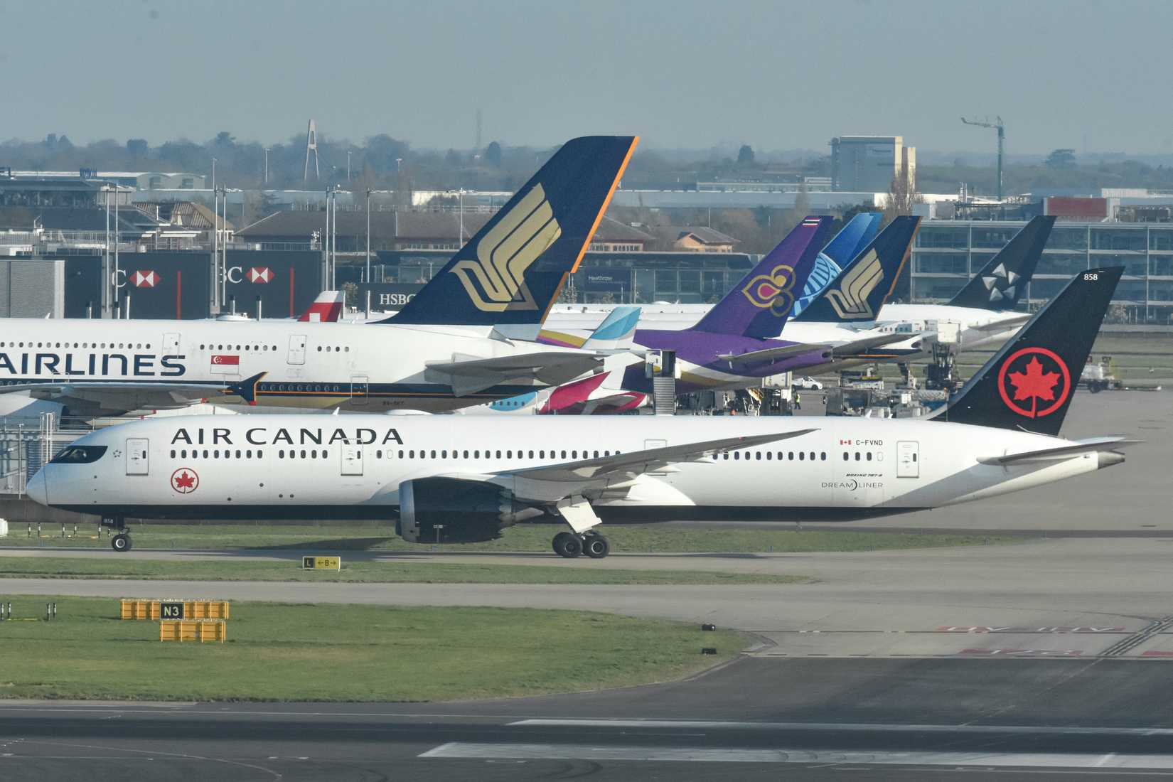 Air Canada Boeing 787-9 aircraft taxiing with Singapore Airlines, Thai Airways aircraft in the background