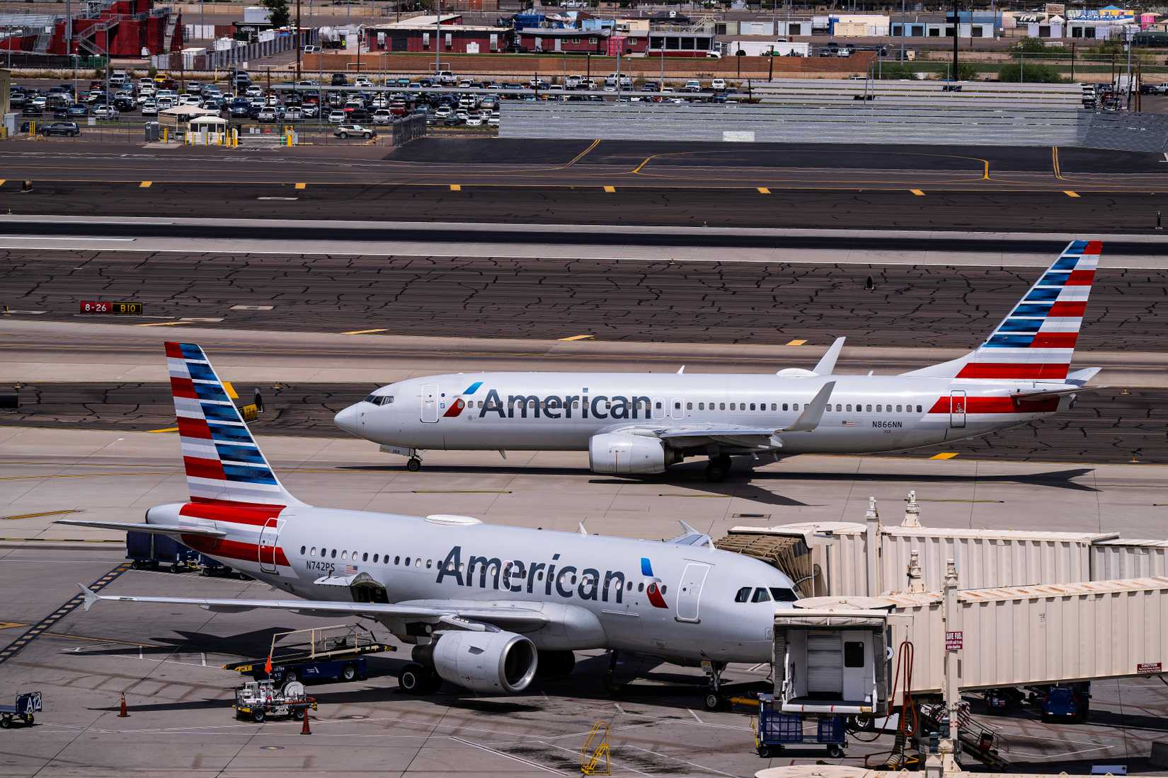 American Airlines Airbus A319-100 Parked And Boeing 737-800 Taxiing