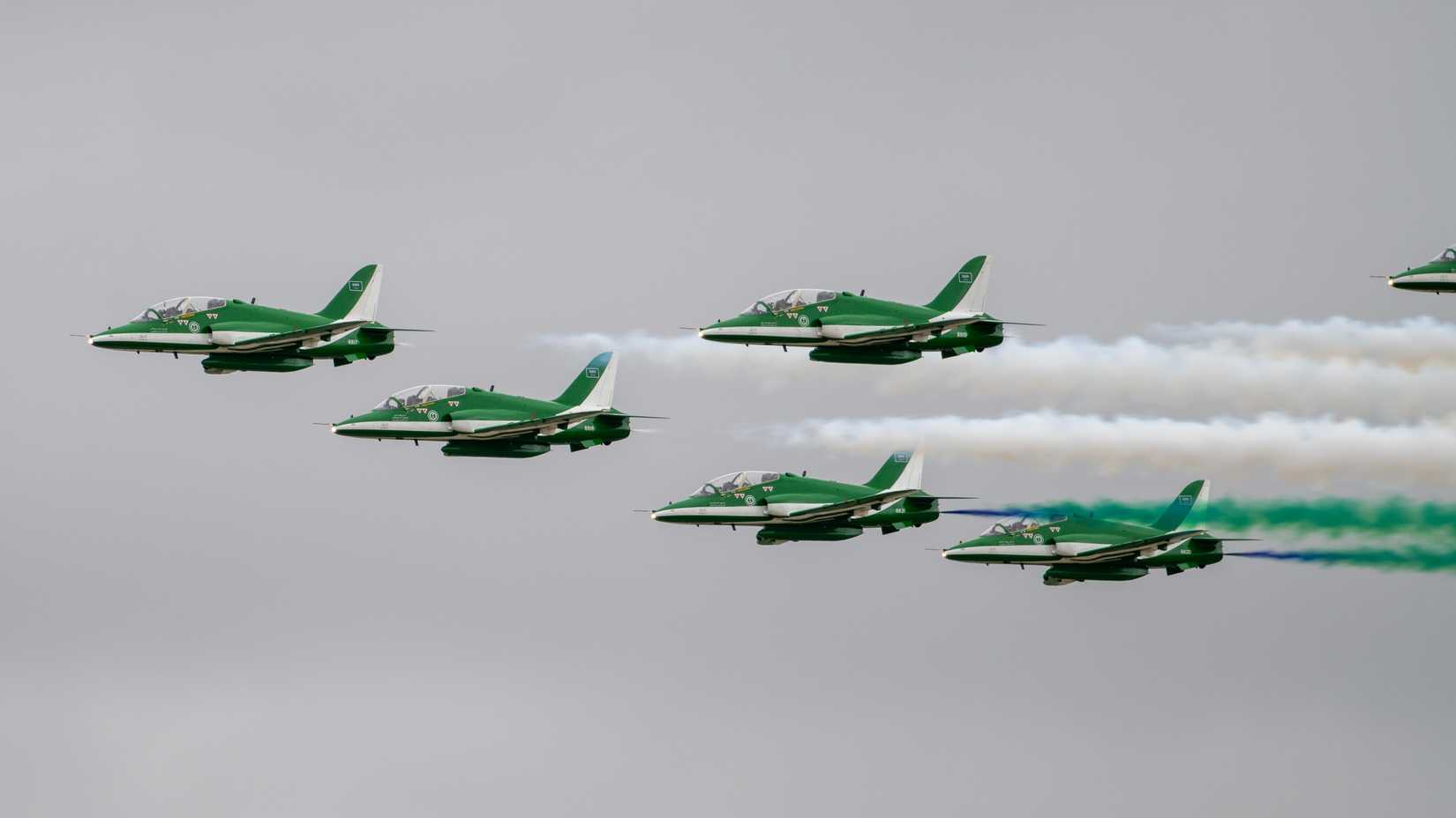 The Royal Saudi Air Force Saudi Hawks aeronautical team conduct an aerial demonstration during the Royal International Air Tattoo