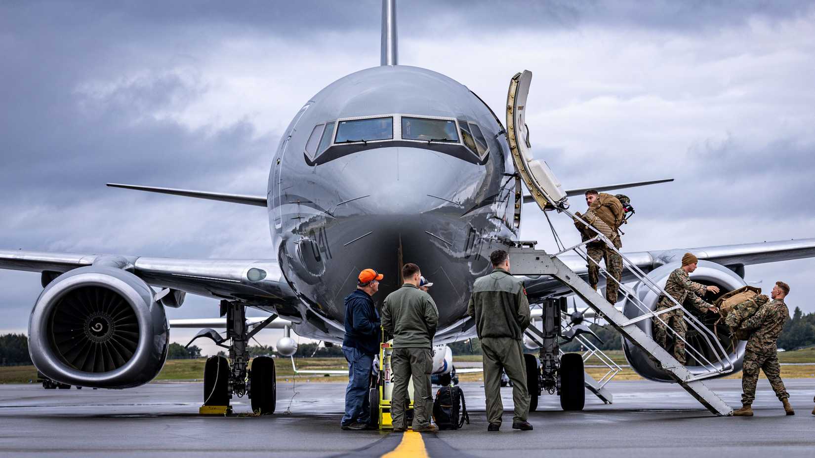 U.S. Marines with 3rd Low Altitude Air Defense Battalion, load a C-40A aircraft, assigned to Marine Transport Squadron (VMR) 1