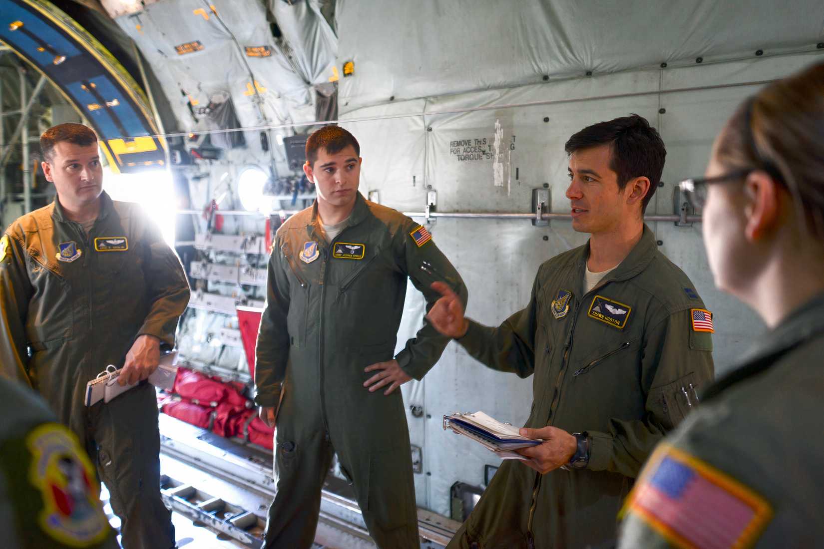 A photo showing training or instruction occurring in a C-130.